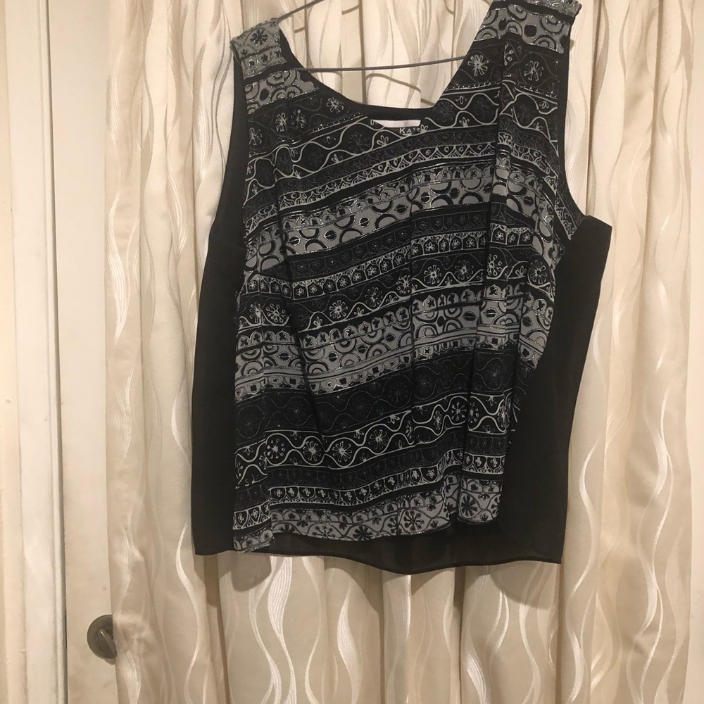 Vest with open blouse.
